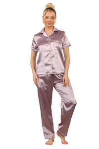 Model wearing a mauve satin two-piece pyjama set with short-sleeve top, collar, and full-length trousers with pockets