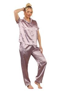 Model wearing a mauve satin two-piece pyjama set with short-sleeve top, collar, and full-length trousers with pockets