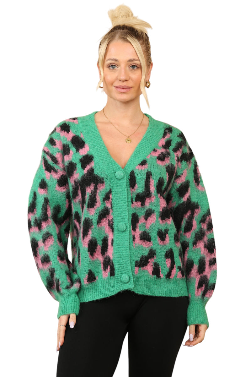 Model wearing a green, pink, and black multi-contrast print cardigan with a deep V-neck and button-down front, made from a polyamide-acrylic blend