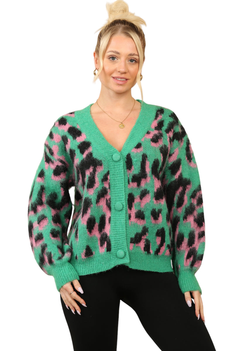 Model wearing a green, pink, and black multi-contrast print cardigan with a deep V-neck and button-down front, made from a polyamide-acrylic blend