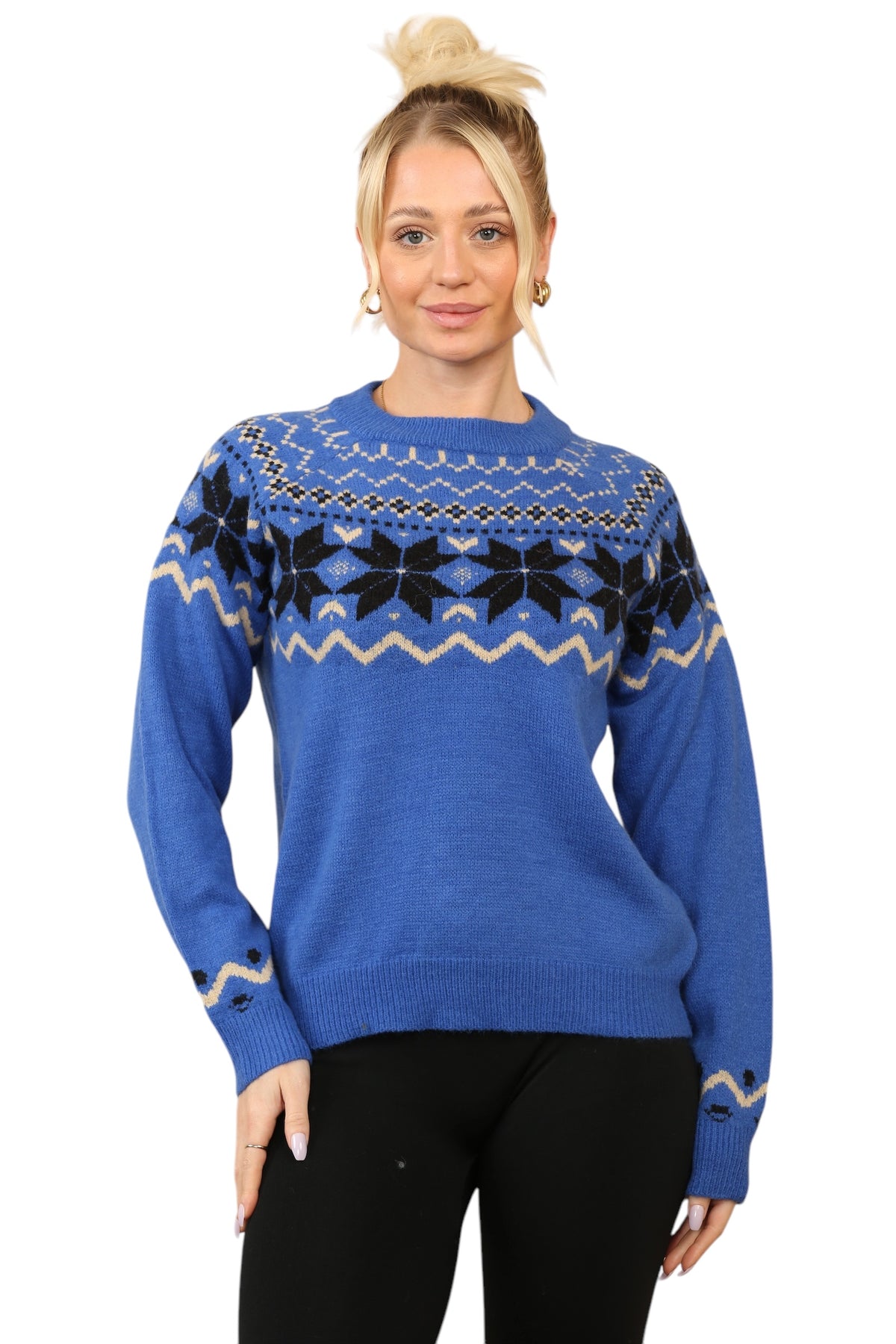 Model wearing a cosy blue Nordic-inspired jumper with a Fair Isle snowflake pattern in black and cream across the chest and sleeves