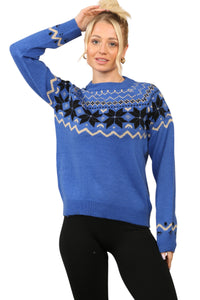 Model wearing a cosy blue Nordic-inspired jumper with a Fair Isle snowflake pattern in black and cream across the chest and sleeves