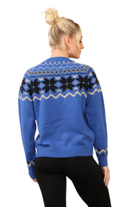 Model wearing a cosy blue Nordic-inspired jumper with a Fair Isle snowflake pattern in black and cream across the chest and sleeves