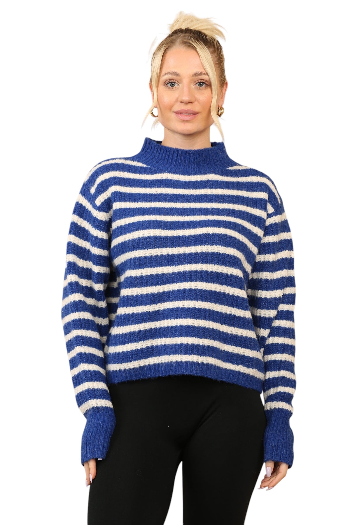 Model wearing a cosy blue and cream striped jumper with a mock neck, long sleeves, and a relaxed fit. The jumper is made of soft acrylic 