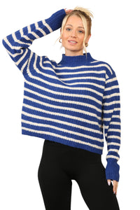 Model wearing a cosy blue and cream striped jumper with a mock neck, long sleeves, and a relaxed fit. The jumper is made of soft acrylic 