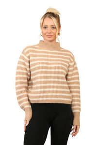 Model wearing a cosy beige and cream striped jumper with a mock neck, long sleeves, and a relaxed fit. The jumper is made of soft acrylic and styled with black leggings