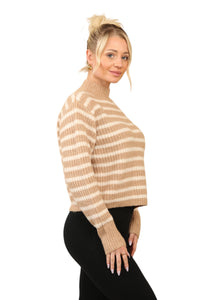 Model wearing a cosy beige and cream striped jumper with a mock neck, long sleeves, and a relaxed fit. The jumper is made of soft acrylic and styled with black leggings