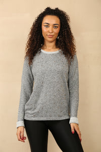 grey knit jumper with scattered stud detailing on the front