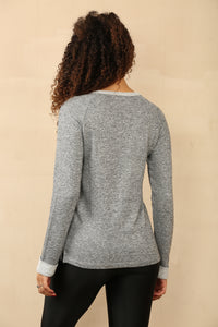 grey knit jumper with scattered stud detailing on the front