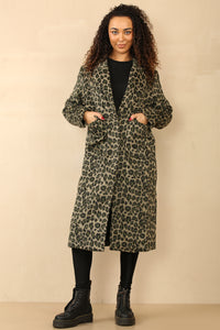 Model wearing a chic, longline leopard print coat with a classic lapel collar and deep pockets