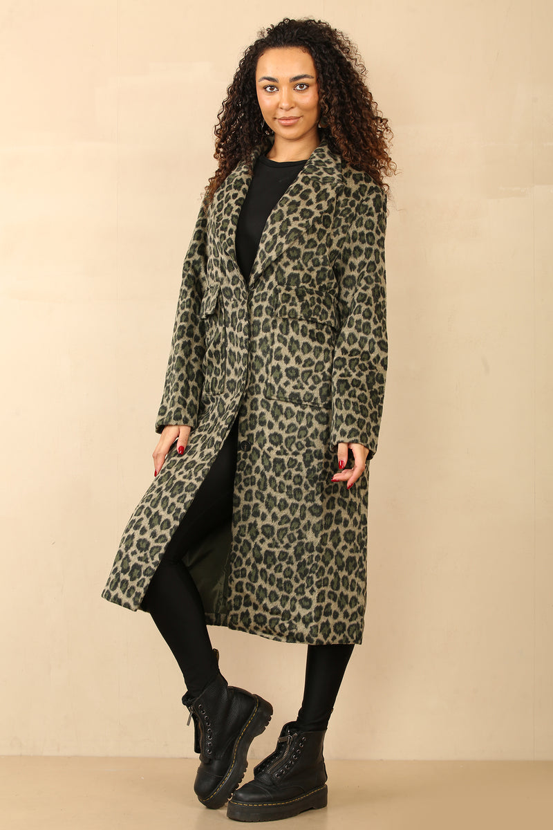 Model wearing a chic, longline leopard print coat with a classic lapel collar and deep pockets