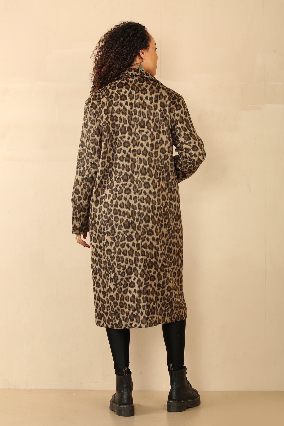 long line leopard print coat with button closure, large front pockets, and a back slit.